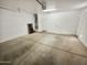 Spacious garage with white walls and concrete flooring, providing ample parking and storage space at 19904 W Sherman St, Buckeye, AZ 85326