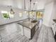 Bright, open-concept kitchen with an island, granite countertops, and a view into the living area at 19904 W Sherman St, Buckeye, AZ 85326