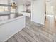 Open-concept living space with modern lighting, tile floors, and seamless flow into the kitchen and backyard at 19904 W Sherman St, Buckeye, AZ 85326