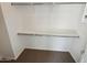 An empty walk-in closet features shelving and hanging rods, ready for customization at 19904 W Sherman St, Buckeye, AZ 85326
