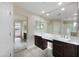 This bathroom features a double sink vanity, framed mirrors and tile floor at 22193 E Via Del Oro --, Queen Creek, AZ 85142