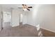 This cozy carpeted bedroom is complete with a ceiling fan and view into other rooms at 22193 E Via Del Oro --, Queen Creek, AZ 85142