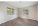 Bright bedroom with carpet, white walls, and two windows offering natural light at 22193 E Via Del Oro --, Queen Creek, AZ 85142