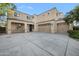 Spacious beige two-story home with a three-car garage and a concrete driveway under a blue sky at 22193 E Via Del Oro --, Queen Creek, AZ 85142