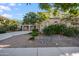 Charming two-story beige home featuring landscaped front yard with green trees and decorative rocks at 22193 E Via Del Oro --, Queen Creek, AZ 85142