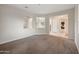 Open-concept living area with carpet, and white walls connected to other rooms at 22193 E Via Del Oro --, Queen Creek, AZ 85142
