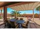 Inviting back patio with dining set, perfect for outdoor entertaining at 279 W Stirrup Ln, San Tan Valley, AZ 85143