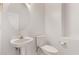 Bathroom with white fixtures and a round mirror at 279 W Stirrup Ln, San Tan Valley, AZ 85143