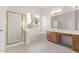 Bathroom features a separate shower and tub, wood cabinets, and tile flooring at 279 W Stirrup Ln, San Tan Valley, AZ 85143