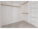 Spacious walk-in closet boasts built in shelving and carpet floors at 279 W Stirrup Ln, San Tan Valley, AZ 85143