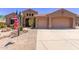 Charming single-story home with a well-manicured desert landscape, complemented by an attached two-car garage at 279 W Stirrup Ln, San Tan Valley, AZ 85143