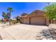 Property with xeriscaping and a wide driveway leading to a two-car garage, with a desert landscape at 279 W Stirrup Ln, San Tan Valley, AZ 85143