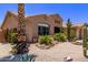 Single-story home showcasing xeriscaping, desert plants, and an attached garage enhancing curb appeal at 279 W Stirrup Ln, San Tan Valley, AZ 85143