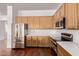 Kitchen with stainless steel appliances and wooden cabinets at 279 W Stirrup Ln, San Tan Valley, AZ 85143