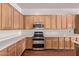 Modern kitchen with stainless steel appliances and wooden cabinets at 279 W Stirrup Ln, San Tan Valley, AZ 85143