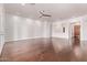 Bright living room with hardwood floors and a modern ceiling fan at 279 W Stirrup Ln, San Tan Valley, AZ 85143