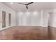 Open room with hardwood floors, natural light, and a ceiling fan, with access to the outdoors at 279 W Stirrup Ln, San Tan Valley, AZ 85143
