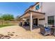 Expansive brick patio featuring an awning and well-maintained landscaping at 2934 S Woodruff Cir, Mesa, AZ 85212