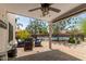 Backyard covered patio with an outdoor dining area and a ceiling fan overlooking the pool at 2934 S Woodruff Cir, Mesa, AZ 85212