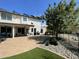 Expansive backyard with a covered patio, lush greenery, and a fenced pool area, creating an ideal outdoor retreat at 2934 S Woodruff Cir, Mesa, AZ 85212
