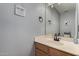 A cozy bathroom includes a sink, toilet, mirror, and decorative wall art at 2934 S Woodruff Cir, Mesa, AZ 85212