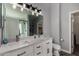 Bright bathroom featuring a double sink vanity, a large mirror, and a glass door shower at 2934 S Woodruff Cir, Mesa, AZ 85212