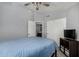 This bedroom features light gray walls, a ceiling fan, and a closet at 2934 S Woodruff Cir, Mesa, AZ 85212