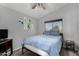 Bedroom featuring a large window, a ceiling fan, and wall art at 2934 S Woodruff Cir, Mesa, AZ 85212
