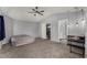 Spacious carpeted bedroom with a vaulted ceiling, ceiling fan, and ensuite bathroom access at 2934 S Woodruff Cir, Mesa, AZ 85212