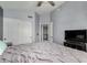 Bedroom features a double closet, closet doors, and a flat screen TV at 2934 S Woodruff Cir, Mesa, AZ 85212