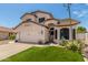 Charming two-story home with a well-manicured lawn, desert landscaping, and a two-car garage at 2934 S Woodruff Cir, Mesa, AZ 85212