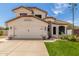 Charming two-story home with a well-manicured lawn, desert landscaping, and a two-car garage at 2934 S Woodruff Cir, Mesa, AZ 85212
