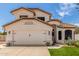 Charming two-story home with a well-manicured lawn, desert landscaping, and a two-car garage at 2934 S Woodruff Cir, Mesa, AZ 85212