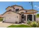 Charming two-story home with a well-manicured lawn, desert landscaping, and a two-car garage at 2934 S Woodruff Cir, Mesa, AZ 85212