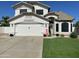 Charming two-story home with a well-maintained lawn and a two-car garage, under a sunny sky at 2934 S Woodruff Cir, Mesa, AZ 85212