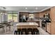 Bright kitchen featuring wood cabinets, stainless steel appliances, and a cozy breakfast bar at 2934 S Woodruff Cir, Mesa, AZ 85212