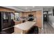 Bright kitchen featuring wood cabinets, stainless steel appliances, and a cozy breakfast bar at 2934 S Woodruff Cir, Mesa, AZ 85212