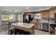Bright kitchen featuring wood cabinets, stainless steel appliances, and a cozy breakfast bar at 2934 S Woodruff Cir, Mesa, AZ 85212
