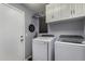 Convenient laundry room featuring a washer, dryer, and ample storage space at 2934 S Woodruff Cir, Mesa, AZ 85212
