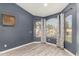 Living room with large windows and a decorative accent wall at 2934 S Woodruff Cir, Mesa, AZ 85212