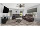 Spacious living room with modern furniture, a ceiling fan, a TV, and views of the backyard at 2934 S Woodruff Cir, Mesa, AZ 85212