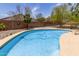 Sparkling pool surrounded by stone decking and privacy fencing at 2934 S Woodruff Cir, Mesa, AZ 85212
