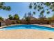 Sparkling swimming pool is surrounded by a spacious patio area and lush landscaping at 2934 S Woodruff Cir, Mesa, AZ 85212