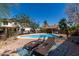 Relaxing backyard swimming pool with lounge chairs, lush greenery, and clear blue water at 2934 S Woodruff Cir, Mesa, AZ 85212