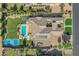 Expansive property featuring a large swimming pool, sport court, trampoline, and lush landscaping at 3010 E Fruitvale Ave, Gilbert, AZ 85297