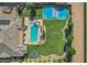 Aerial view of single-Gathering home with backyard including pool, lounge chairs, playground, and recreational area at 3010 E Fruitvale Ave, Gilbert, AZ 85297