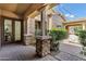 A back patio showcasing stone pillar construction, brick pavers, and verdant shrubbery at 3010 E Fruitvale Ave, Gilbert, AZ 85297