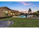 Spacious backyard with pool, waterslide, trampoline, and lush green lawn, perfect for outdoor fun at 3010 E Fruitvale Ave, Gilbert, AZ 85297
