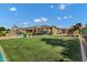 A sprawling backyard includes a pool, playground, and expansive grassy area at 3010 E Fruitvale Ave, Gilbert, AZ 85297