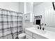 Bathroom featuring a marble countertop, modern fixtures, and a shower with a striped curtain at 3010 E Fruitvale Ave, Gilbert, AZ 85297